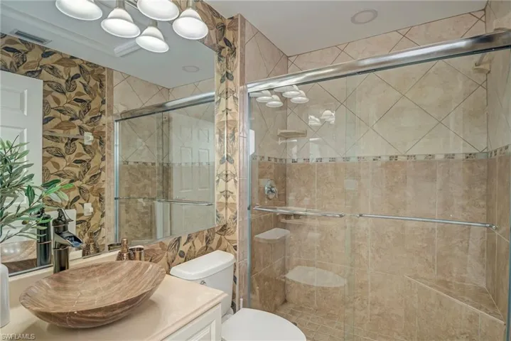Full bath with vanity and a shower stall