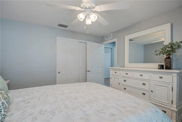 Bedroom featuring ceiling fan and a closet
