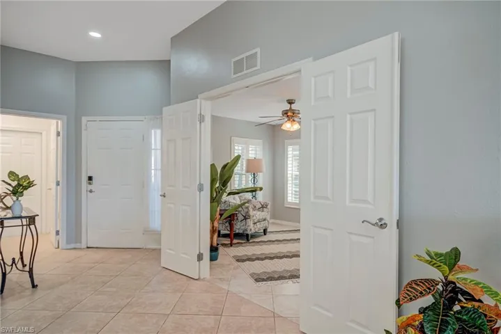 Entrance foyer with ceiling fan and light tile patterned floors