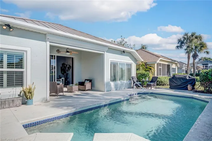Outdoor pool with a patio and grilling area