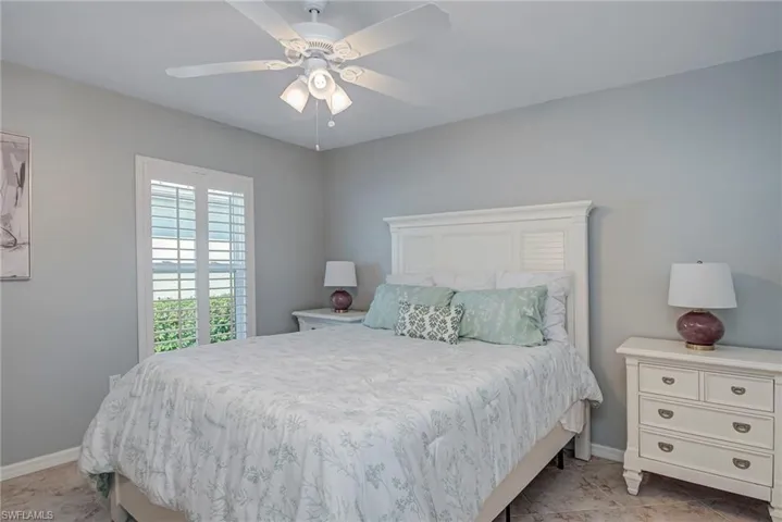 Bedroom featuring a ceiling fan and baseboards