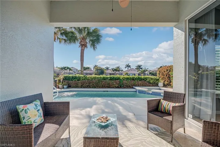View of swimming pool featuring a patio area, a pool with connected hot tub, and a residential view
