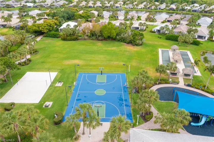 Aerial view of residential area featuring a nearby body of water