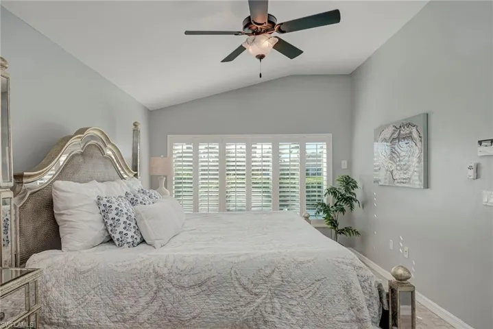 Bedroom featuring vaulted ceiling and a ceiling fan