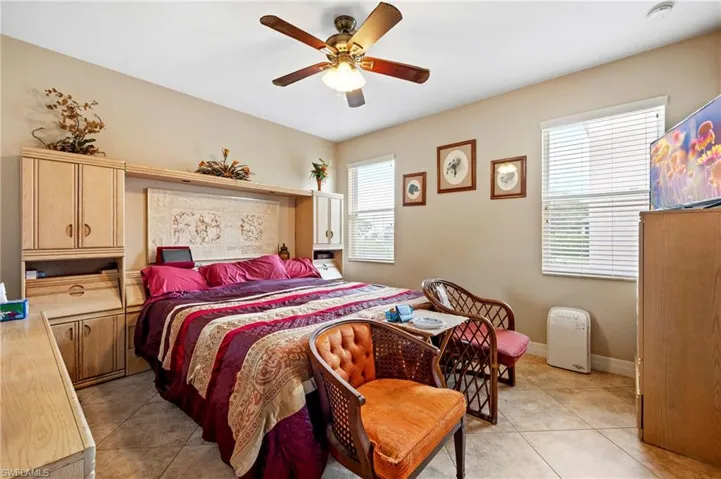 Bedroom featuring light tile patterned floors and a ceiling fan