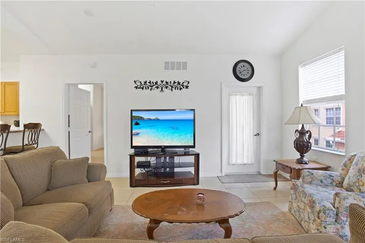 Living area featuring light tile patterned flooring and baseboards