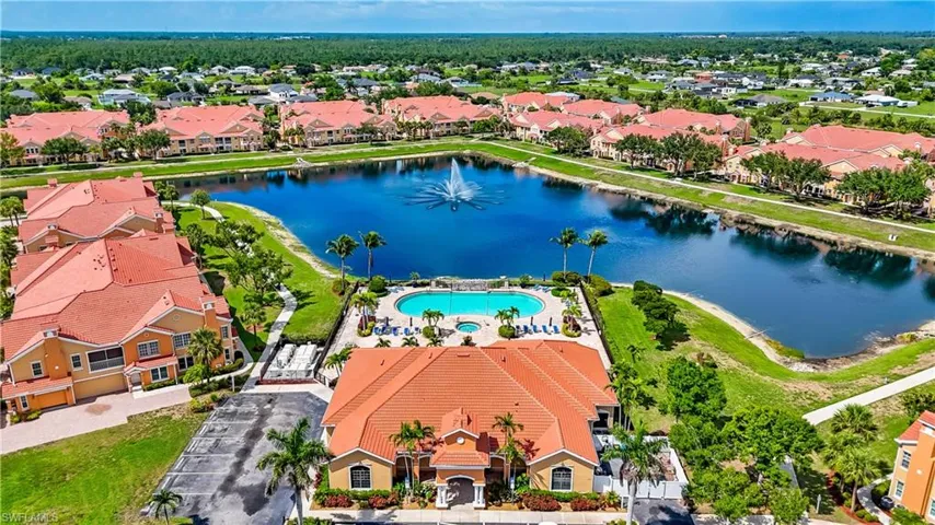 Aerial view of residential area with a large body of water and a pool area