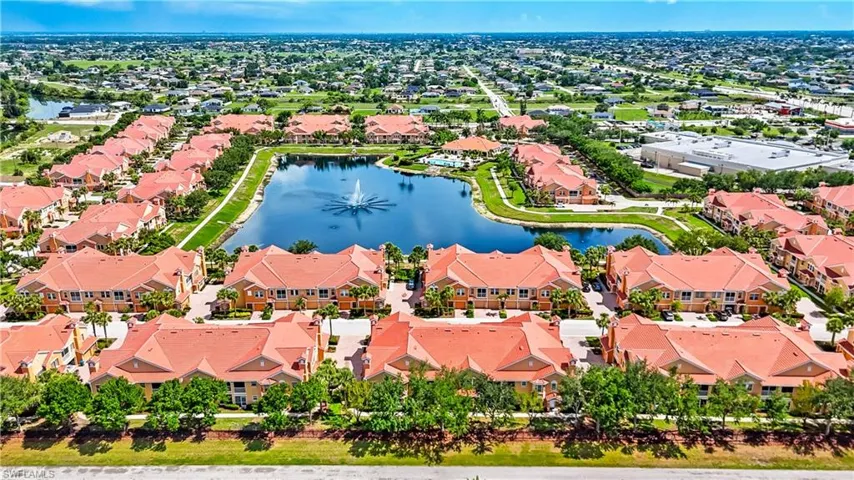 Aerial view of residential area featuring a nearby body of water