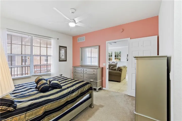 Bedroom featuring light carpet and ceiling fan