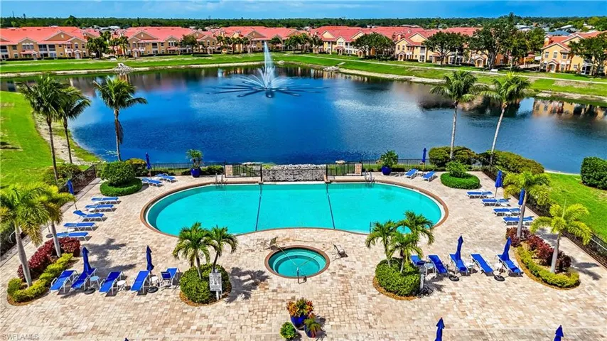 Community pool featuring a water view and a residential view