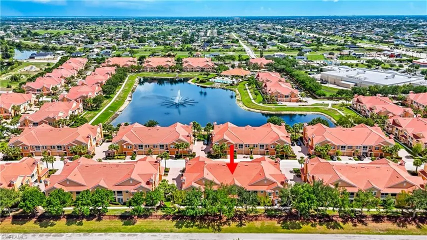Aerial perspective of suburban area featuring a nearby body of water
