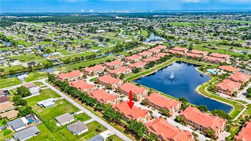 Aerial view of residential area featuring a large body of water