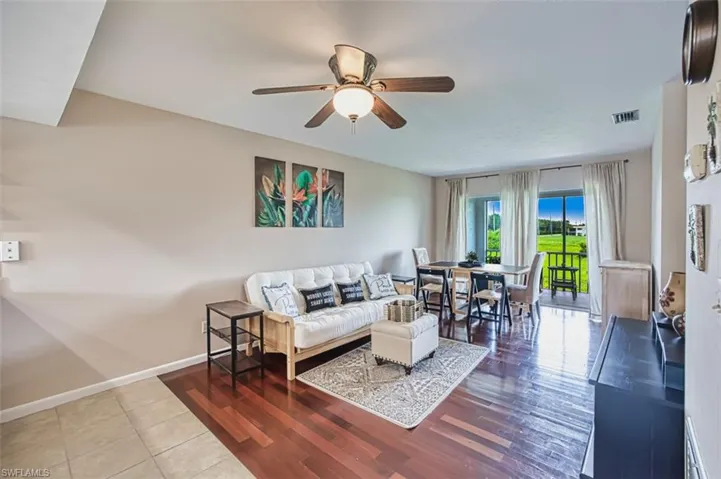Living room with ceiling fan and wood finished floors