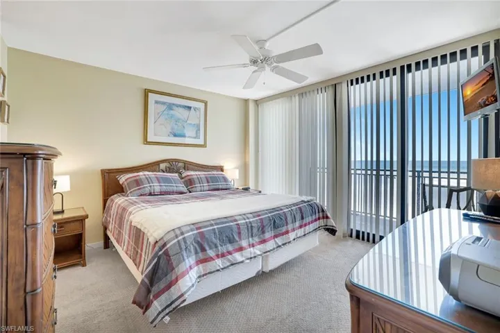 Bedroom with carpet, access to outside, ceiling fan, and baseboards