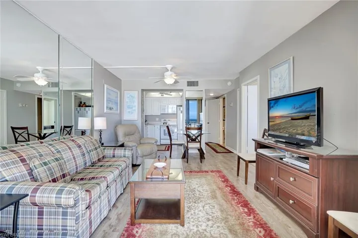 Living area with ceiling fan and light wood-type flooring