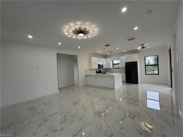 Unfurnished living room with sink