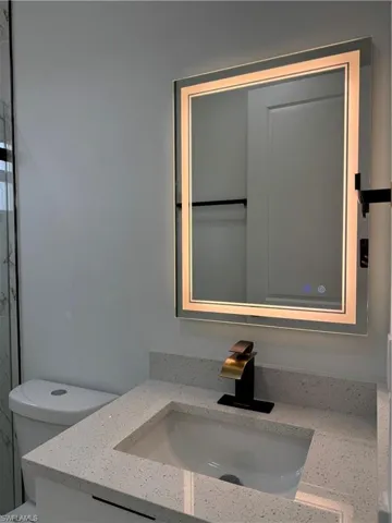 Bathroom featuring vanity and toilet