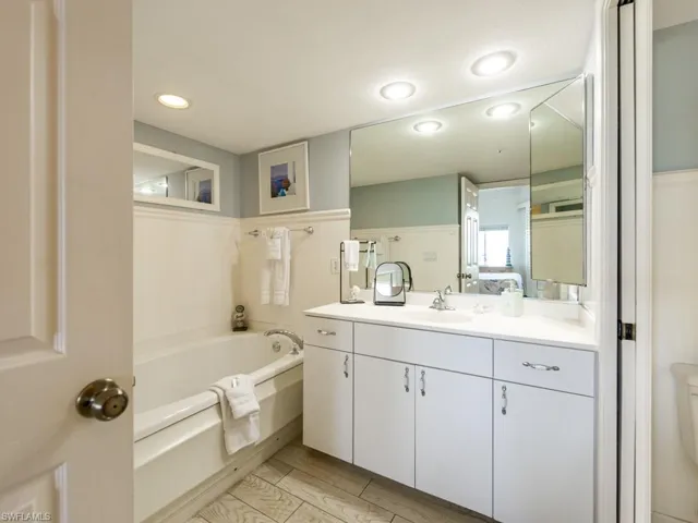 Bathroom with a garden tub, vanity, ensuite bathroom, and recessed lighting