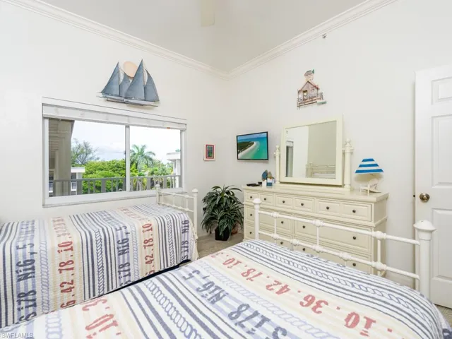 Bedroom with crown molding and a ceiling fan