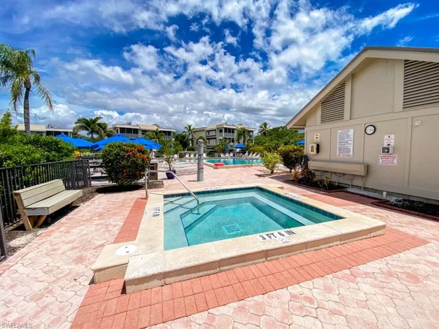 Community pool with a hot tub and a patio