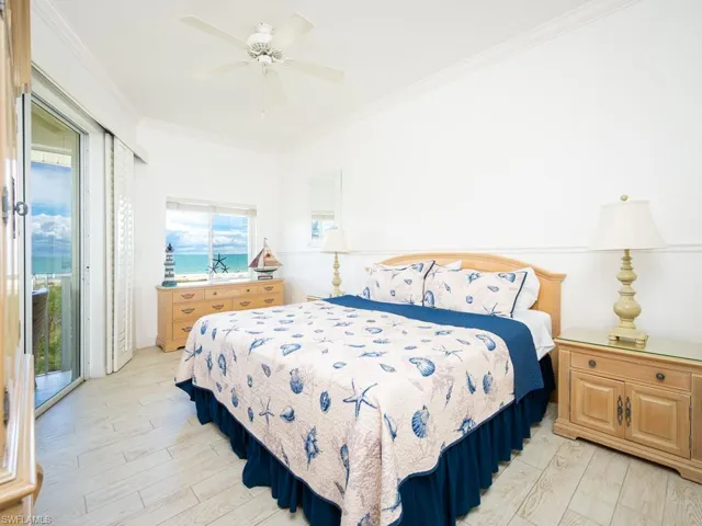 Bedroom with access to outside, light wood-style floors, ornamental molding, and ceiling fan