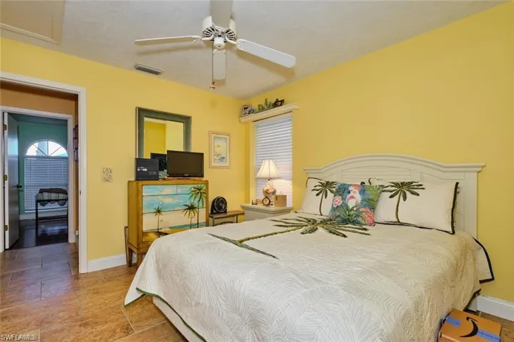 Bedroom featuring ceiling fan and tile patterned flooring