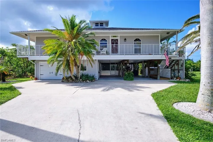 Coastal home featuring a carport and a porch