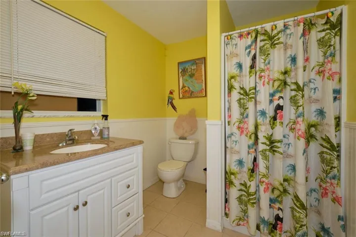Bathroom with tile patterned floors, toilet, and vanity