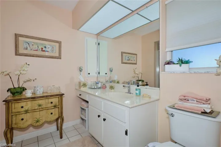 Bathroom with vanity, tile patterned floors, and toilet