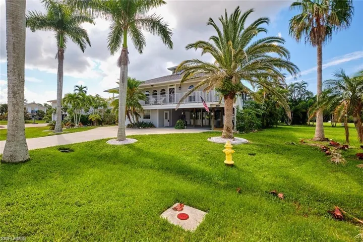 View of front facade with a carport and a front lawn