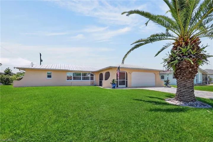Single-story residence featuring a low-slope roof, stucco exterior, and an attached garage with a white door