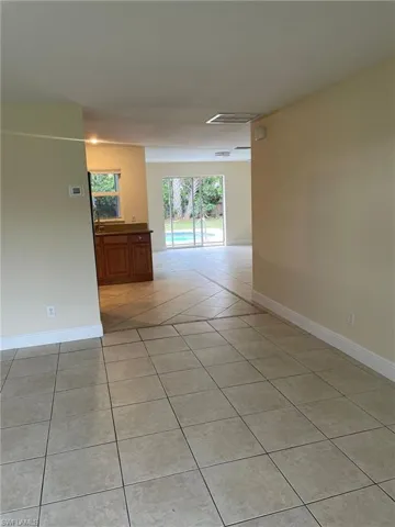 Empty room featuring visible vents, baseboards, and light tile patterned flooring