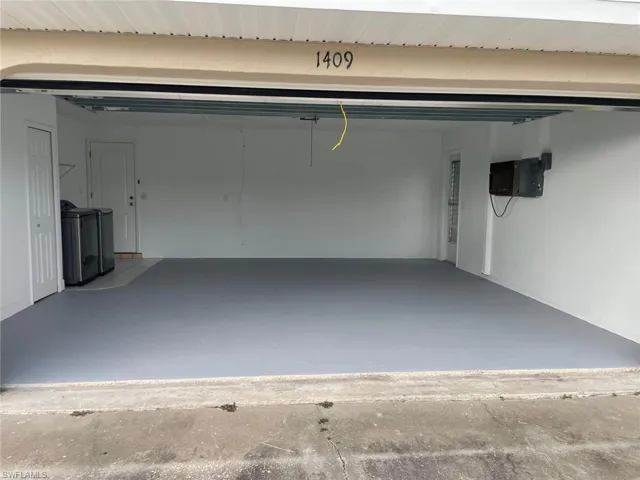 Garage featuring washing machine and dryer