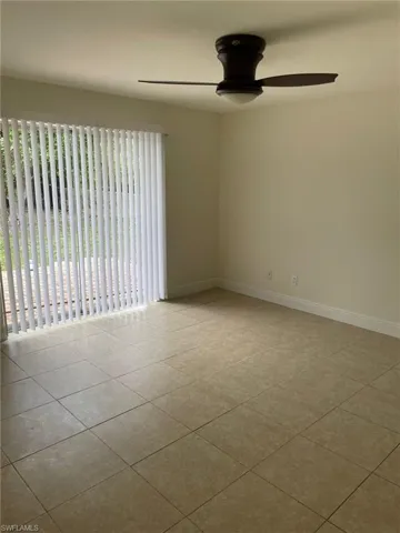 Spare room featuring tile patterned floors, baseboards, and ceiling fan