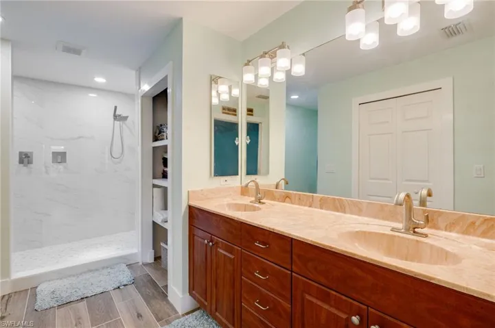 Double sinks, new lighting and shelving nook for storage.