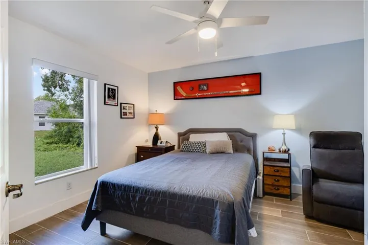 Bedroom #3 at the back of the house with sliders to the pool/lanai area