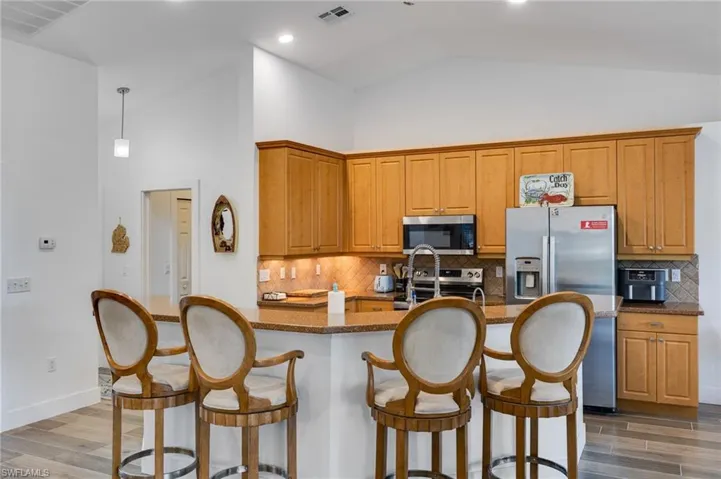 Kitchen with large island, under cabinet lighting and 42" cabinets.