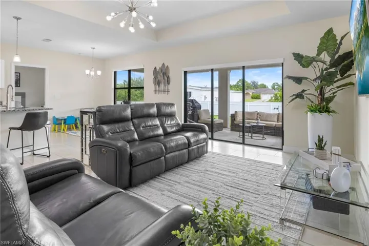 Rear view of property with a fenced backyard, a patio, and stucco siding
