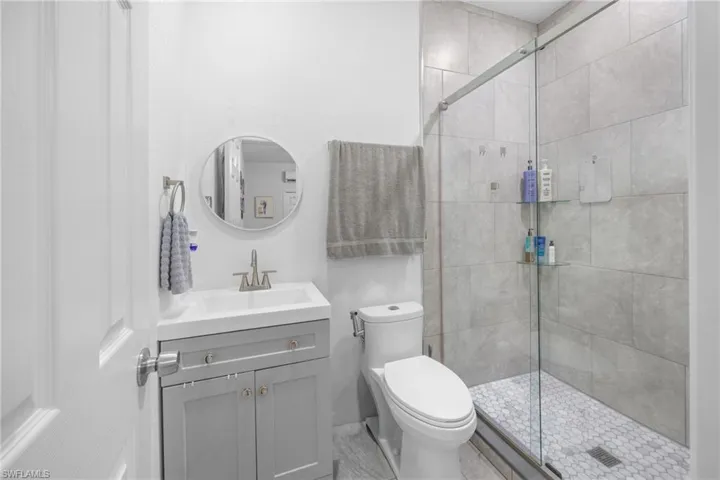 Bathroom with a shower stall and vanity