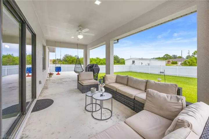 Fenced backyard featuring outdoor lounge area, a ceiling fan, and a patio