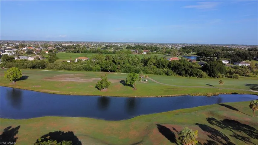 Expansive aerial perspective showcasing a golf course with multiple greens and fairways