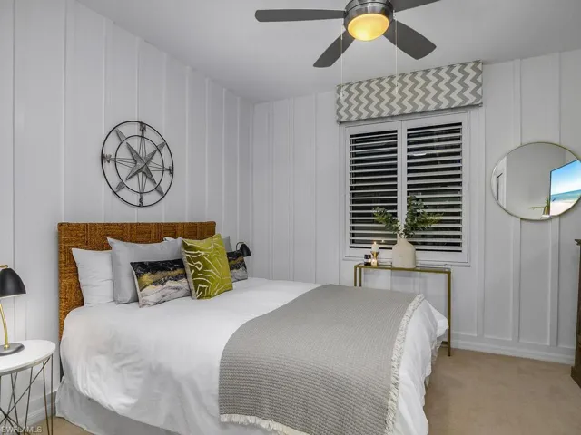Bedroom with light carpet and ceiling fan