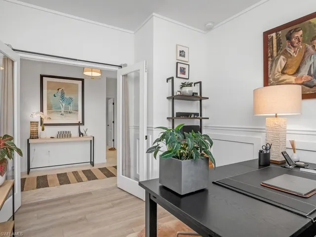 Office space with crown molding and light hardwood / wood-style floors