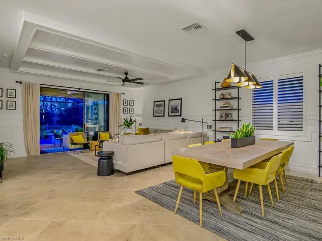 Tiled dining space featuring crown molding and ceiling fan