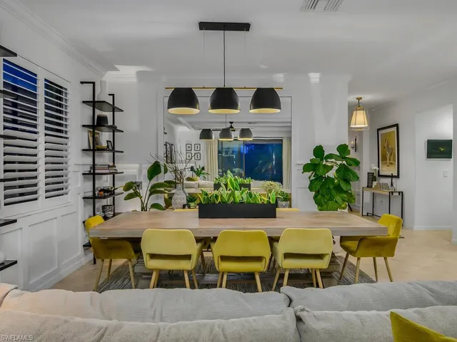 Tiled dining space featuring ornamental molding