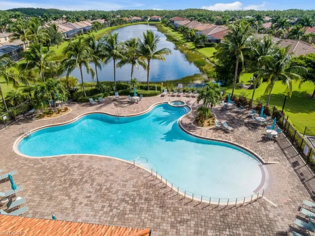View of swimming pool featuring a water view and a patio area