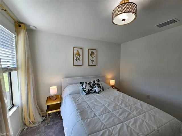 Bedroom with dark colored carpet