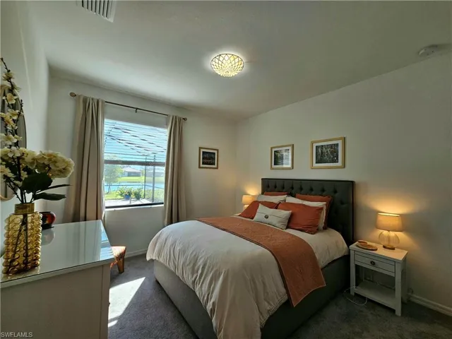 Bedroom featuring carpet and baseboards