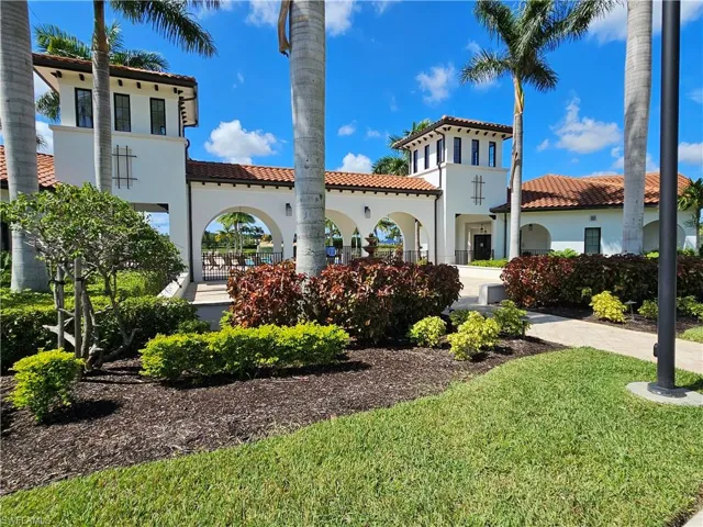 Town Center featuring a tiled roof, stucco siding, and a yard