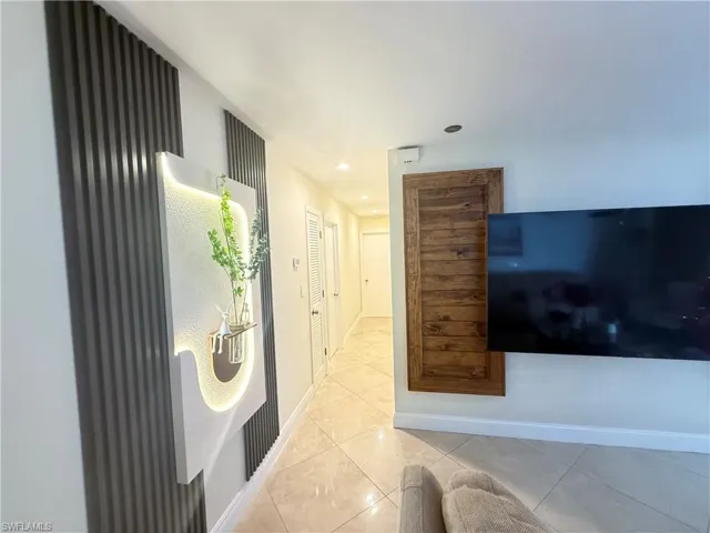Corridor with tile patterned flooring and recessed lighting